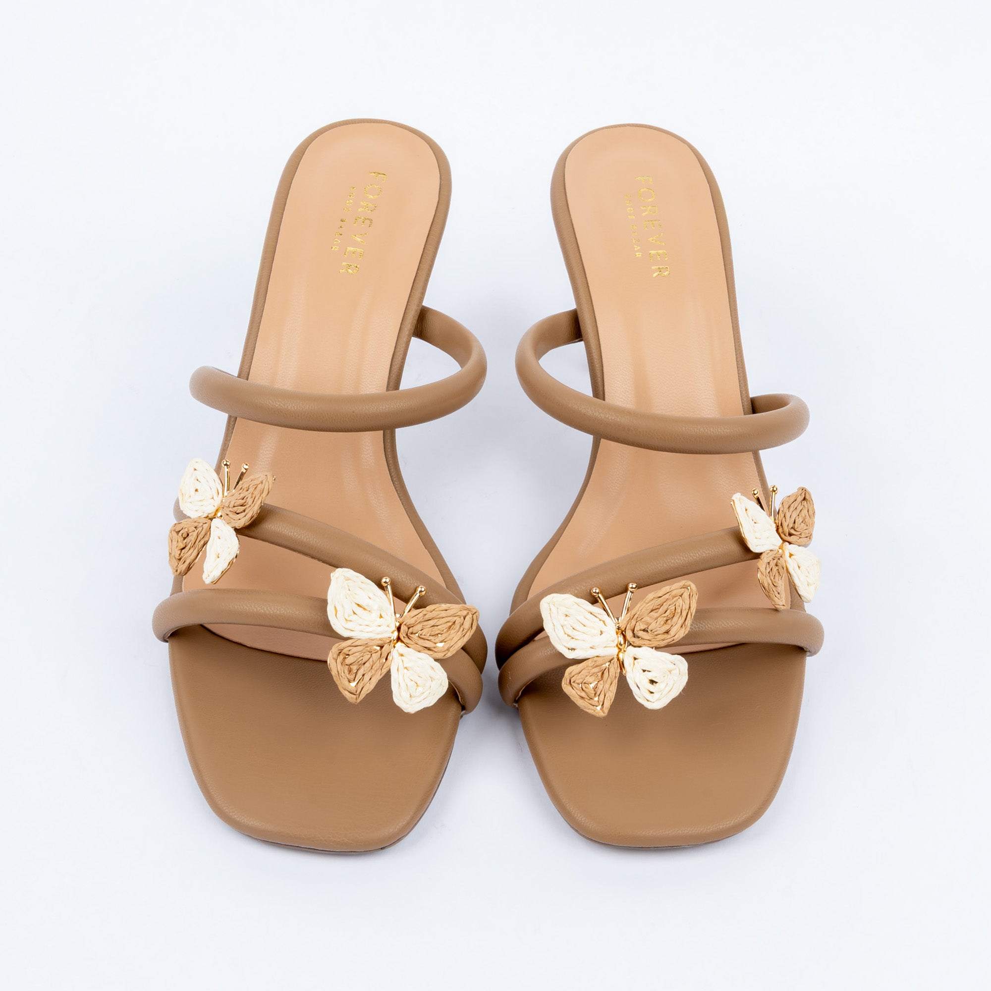 Beige slim heel mules styled for casual wear