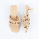 Beige kitten heel mules for women, two hand-woven bands - an airy open-lattice band over a tight basket-weave vamp - above a matching footbed, squared toe edge and slim tapered kitten heel