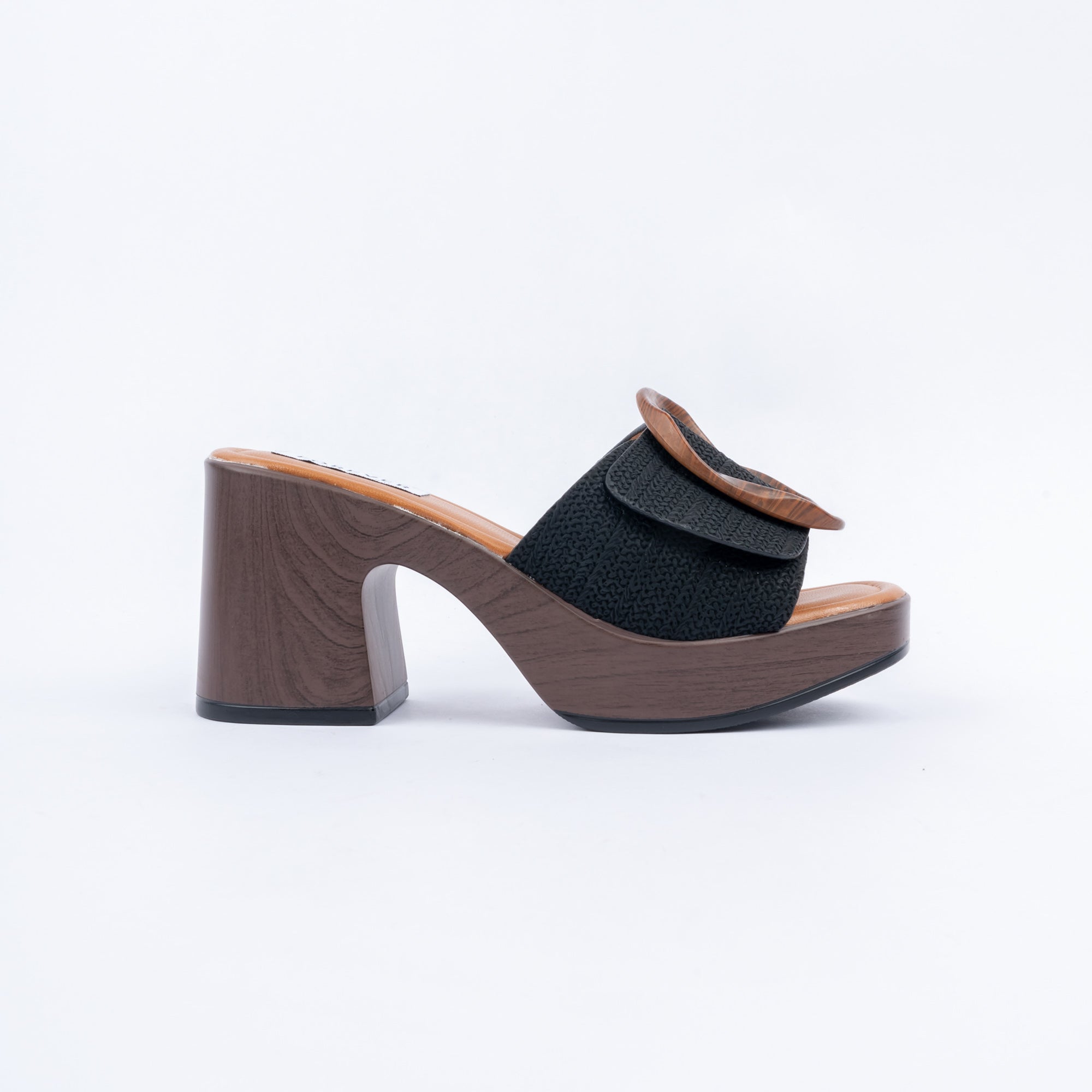 Black platform heel mules for women, a tortoiseshell ring laid across a basket-woven band