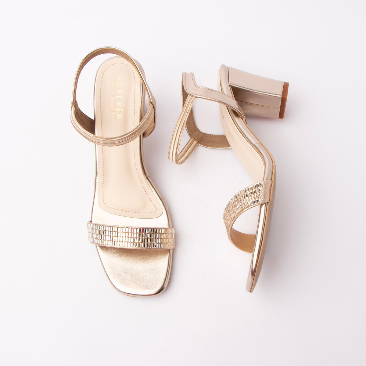 Gold embellished block heel sandals for women, a wide toe band inset with rows of small mirrored square stones above a piped sling strap that runs round the heel onto a stretch gore panel, in light champagne gold metallic pu throughout, over a cream leatherette footbed stitched around the edge and a flared block heel finished in the same gold metallic as the upper