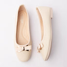 Beige bow ballerina flats styled for everyday wear
