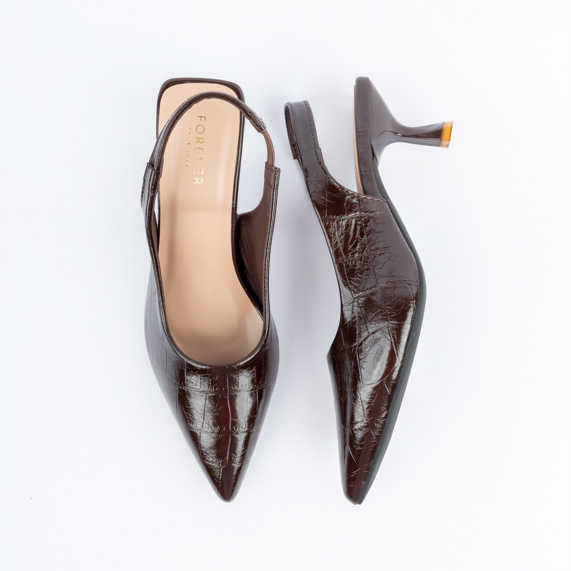 Coffee brown pumps for women, a high-gloss croc-embossed upper drawn to a needle point, with a narrow elasticated slingback and a blush-nude branded footbed