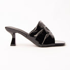 Black patent mules for women, a jet-black patent mule whose gathered instep band is split into three soft tiers by two slim raised straps, the lowest running diagonally across a wide square opening, on a slim flared spool heel in matching patent