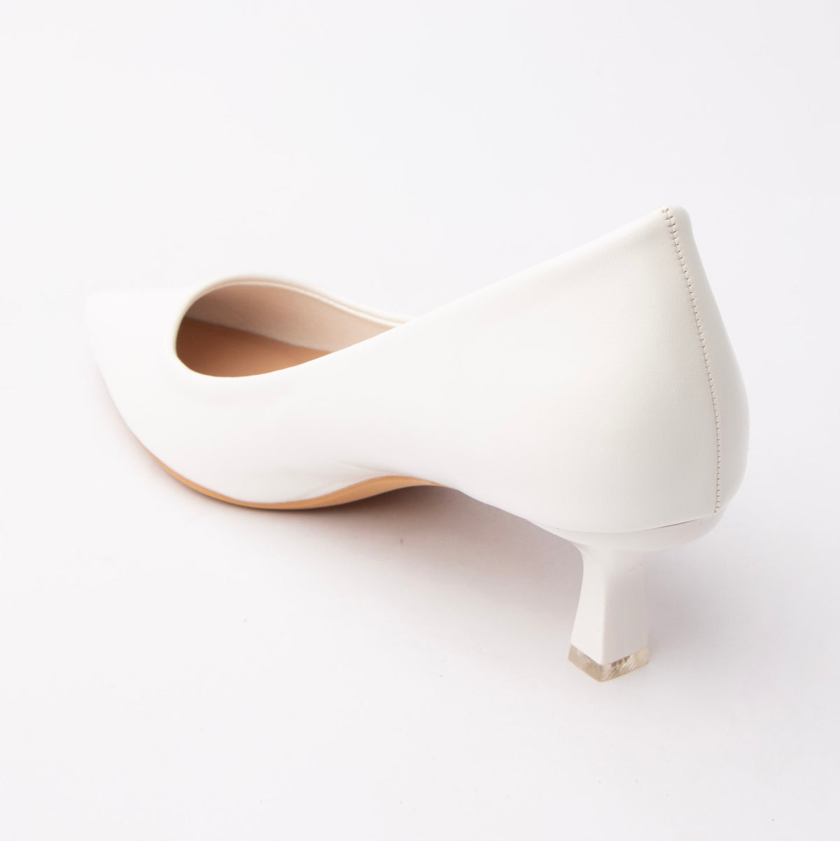 White pointed court shoes for women, back view showing the heel