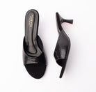 Black snake print kitten heel mules for women, a single broad snake-embossed band in high-gloss black sweeps across the vamp and leaves the toe and heel open, sitting on a plain black leather-look footbed stamped with the gold foil logo, above an all-black flared hourglass kitten heel that finishes on a black tip