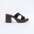 Black platform heel mules for women, crossed woven bands meeting under a gold swirl ornament
