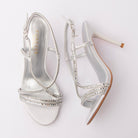 Silver sandals for women, both shoes laid flat