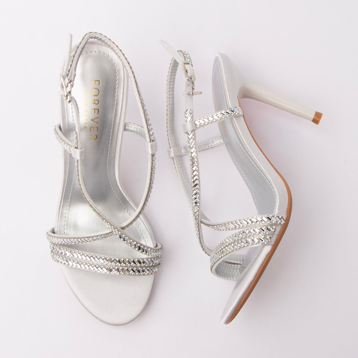 Silver sandals for women, both shoes laid flat