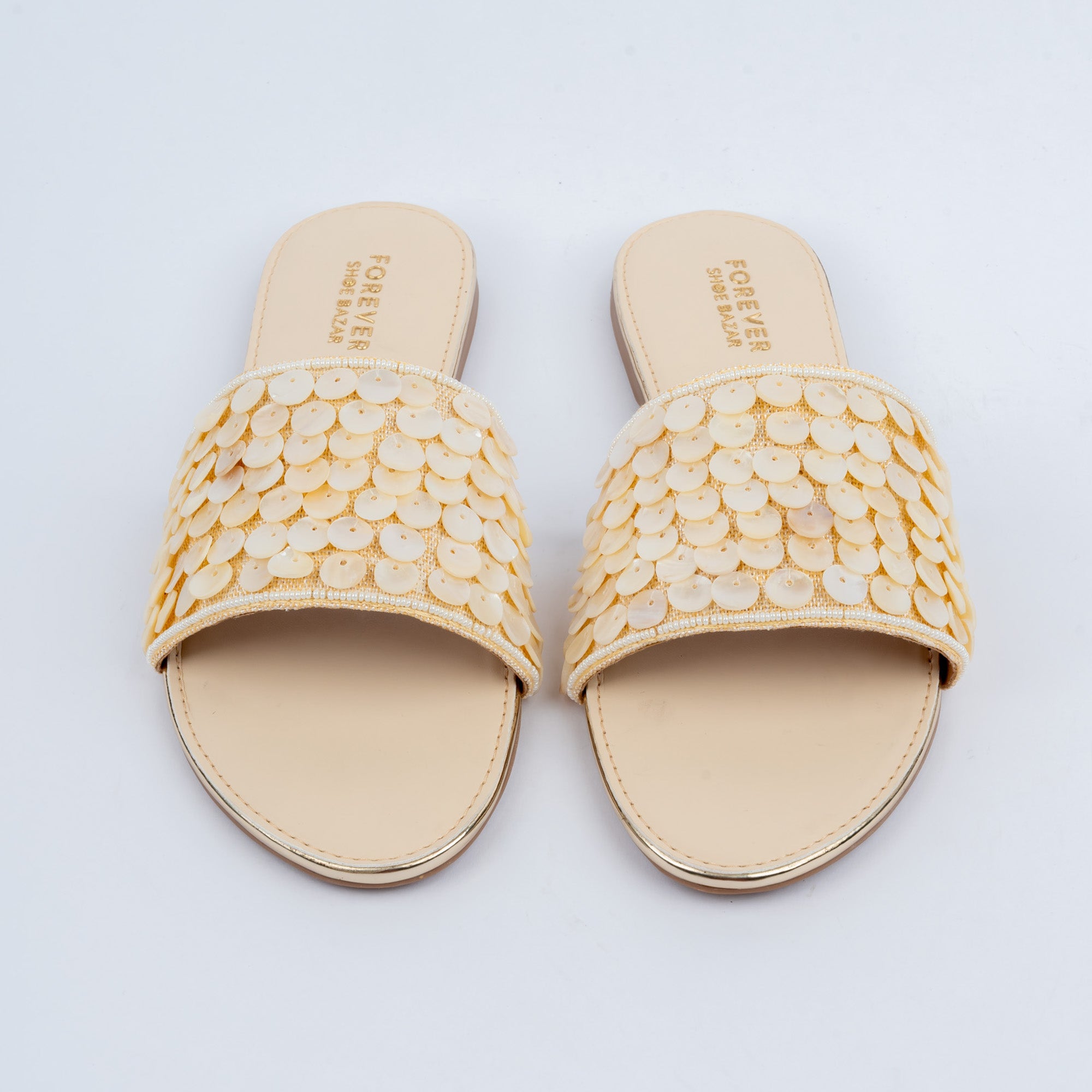 Gold floral embellished flats styled for everyday casual wear