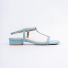 Blue block heel sandals for women, a clean T-strap of narrow bands joining a toe band to a centre stem and a full ankle loop fastened by a small gold pin buckle, on a cream contrast footbed and a squared-off low block heel
