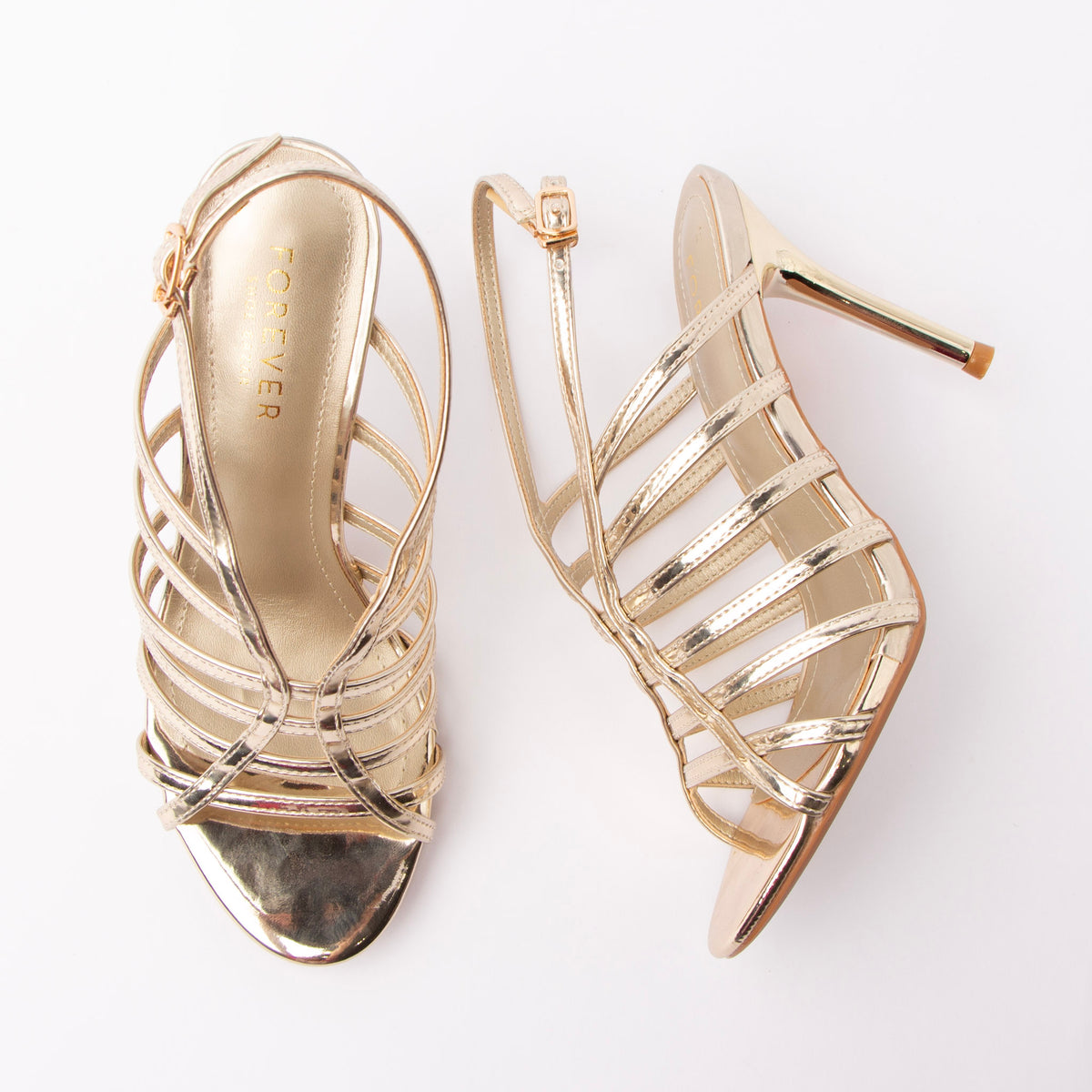 Gold sandals for women, both shoes laid flat