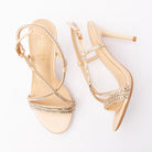 Gold sandals for women, both shoes laid flat