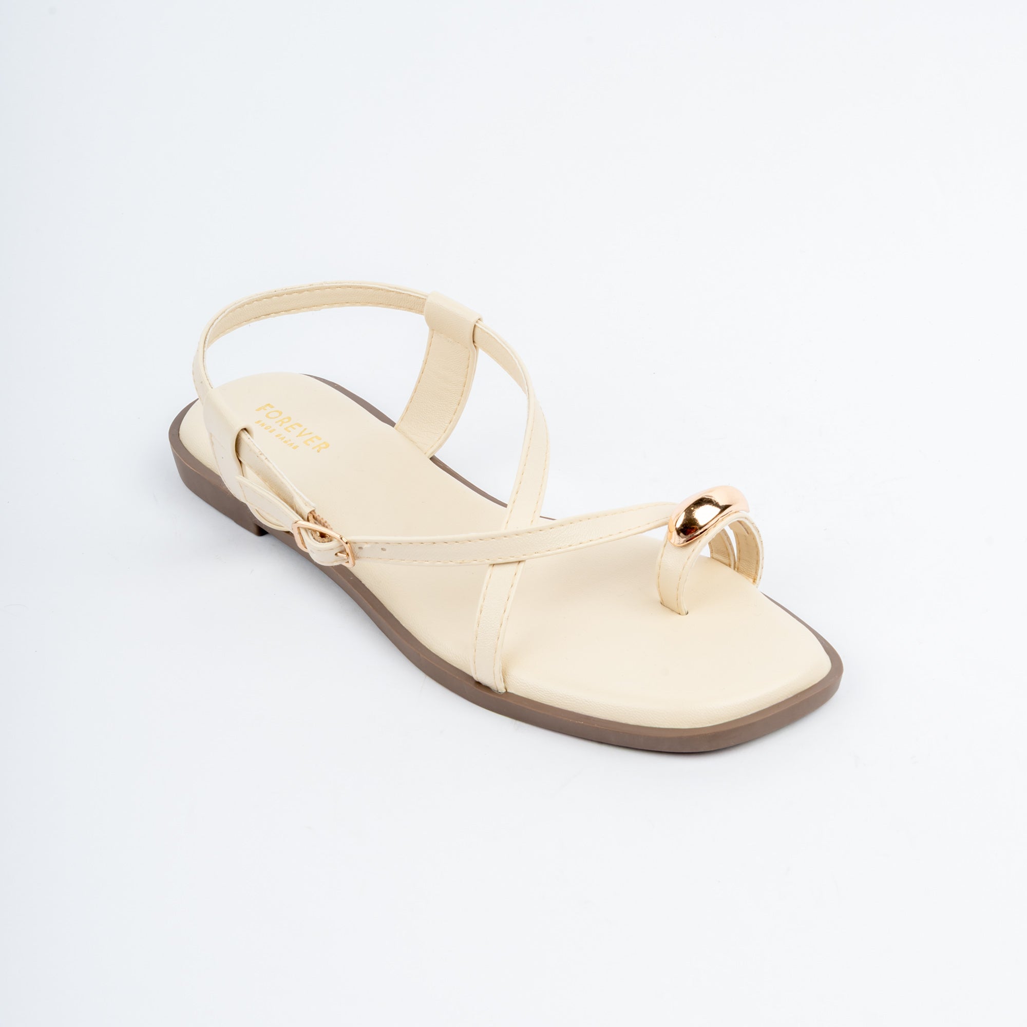 Cream flat sandals styled for casual wear