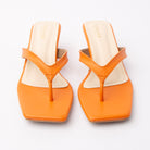 Orange toe-post kitten heel mules for women, both shoes from the front