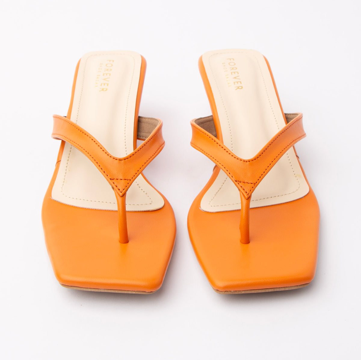 Orange toe-post kitten heel mules for women, both shoes from the front