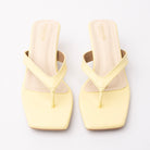Yellow toe-post kitten heel mules for women, both shoes from the front