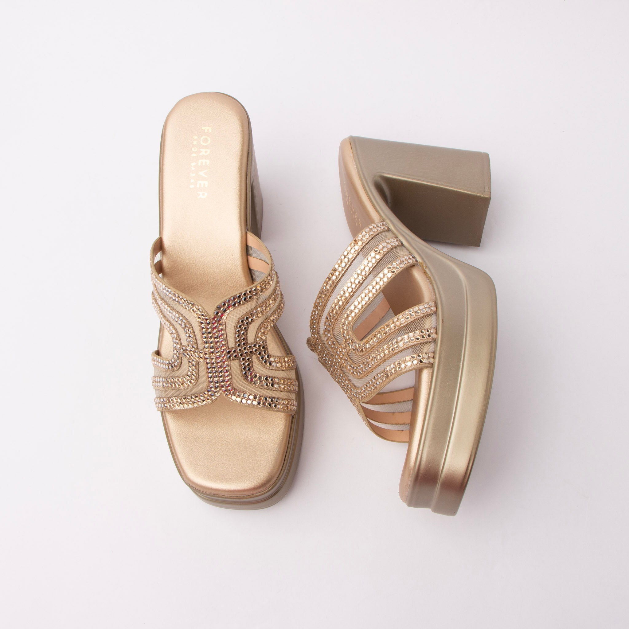 Gold beaded platform mules for women, soft antique-gold metallic pu worked into a swirled multi-band vamp, its curved ribs filled with warm gold stones and separated by gold mesh insets, carried on a gold footbed and a gold-covered platform with a heavy squared block heel