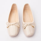 Cream patent ballerina flats styled for everyday wear