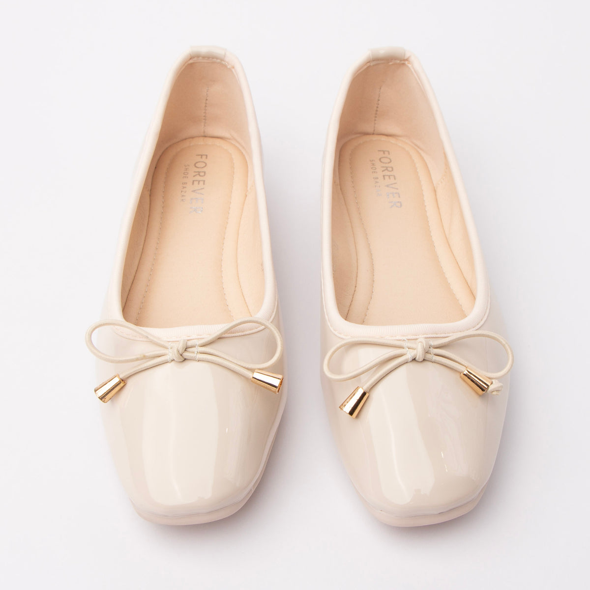 Cream patent ballerina flats styled for everyday wear
