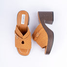 Camel platform heel mules for women, a woven raffia-look band crossed by a gold buckle strap