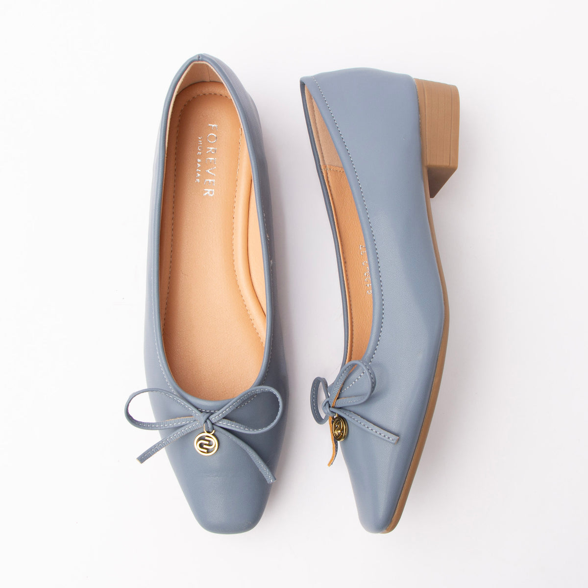 Blue pumps for women, both shoes laid flat