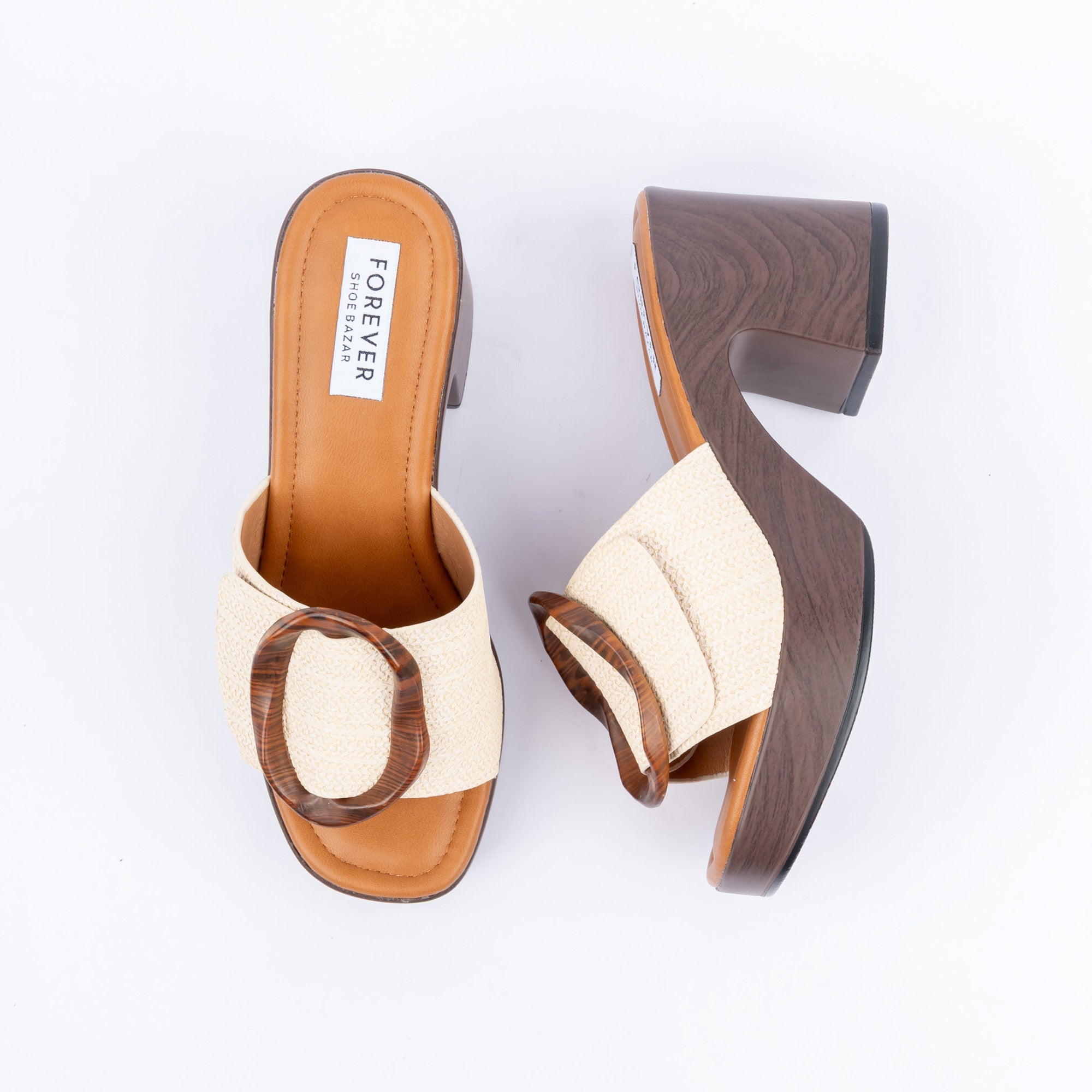 Beige platform heel mules for women, a tortoiseshell ring laid across a basket-woven band