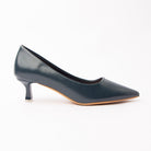 Blue pointed court shoes for women, a deep petrol-blue pointed court in a matte finish, teal-leaning rather than royal, on a sculpted kitten heel capped in silver-tone metal over a contrasting natural tan sole edge