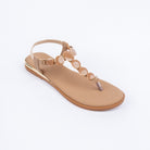 Beige flat sandals styled for casual wear