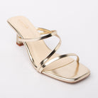 Gold kitten heel mules styled for casual wear