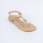 Gold flat sandals styled for party wear