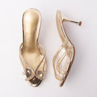 Gold mules for women, both shoes laid flat