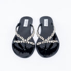 Black flat sandals styled for casual wear
