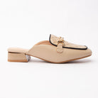 Khaki quilted loafer mules for women, a soft cream loafer mule with a diamond-quilted apron outlined in fine black grosgrain piping, a tonal keeper strap carrying a gold snaffle bar, and a low block heel wrapped with a gold plate above a cream-nude footbed