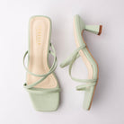 Green mules for women, both shoes laid flat