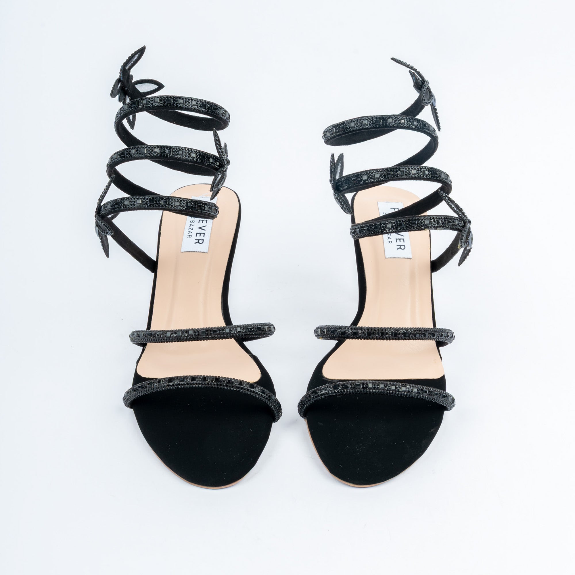 Black block heel sandals for women, two crystal-set straps over the vamp, topped by a coiled spiral ankle wrap studded with the same stones and punctuated by three flat butterfly motifs, on a blush footbed