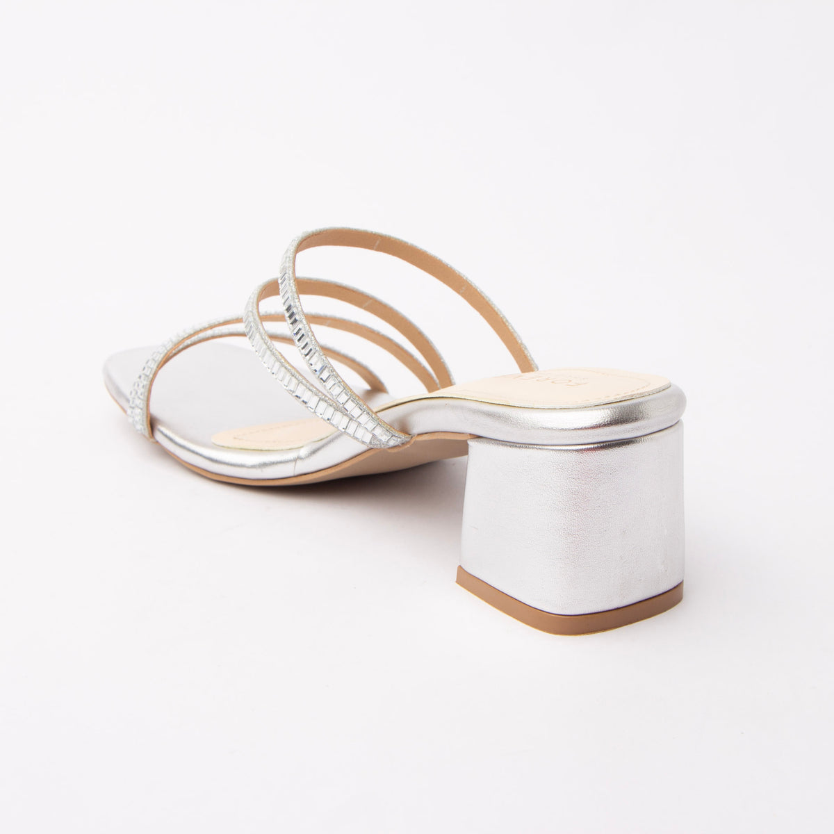 Silver criss cross strap mules for women with cushioned footbed, side view