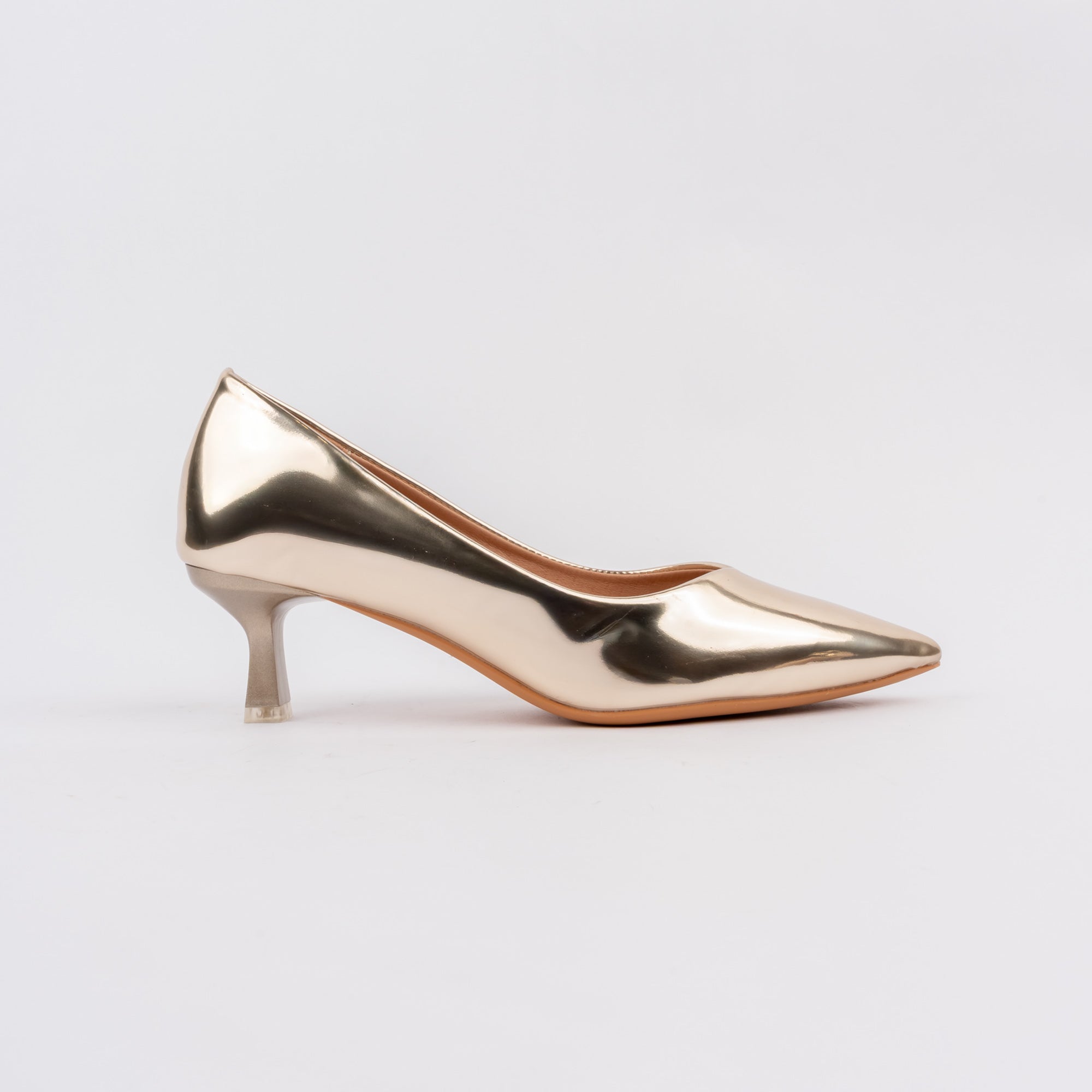 Gold pumps for women, an unbroken mirror-finish metallic upper with a low V-cut topline and a flared spool kitten heel tipped with a clear translucent block