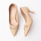 Khaki crystal court shoes for women, twin crystal-pave strands loop and cross into a knotted bow over the vamp of a khaki satin pointed-toe court shoe, slipping on without a fastening above a nude padded footbed and a flared spool heel with a clear tip