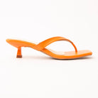 Orange toe-post kitten heel mules for women, side view of the twisted vamp band, squared-off open toe and slim kitten heel