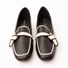 Black piped block heel loafers styled for everyday wear
