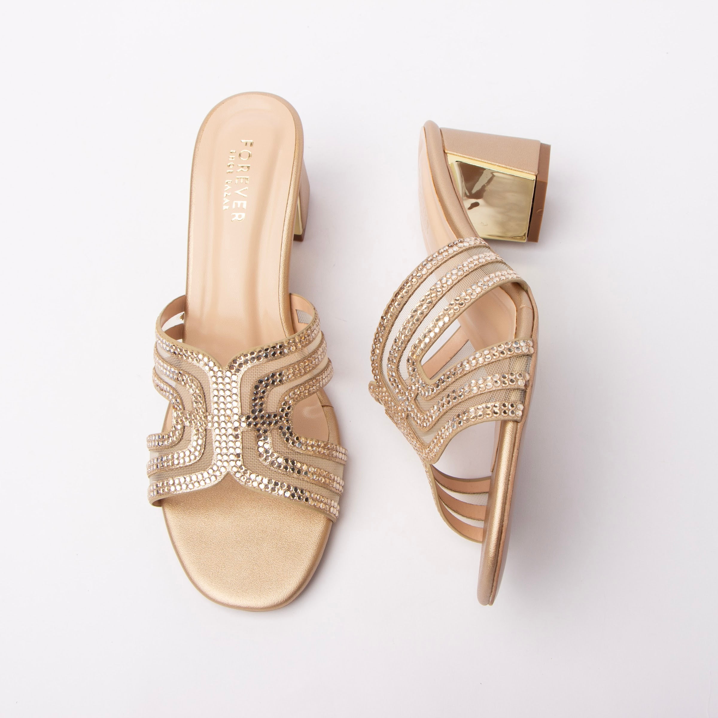 Gold block heel mules for women, arched bands of close-set crystals over sheer mesh cut-outs on the vamp, a metallic footbed and a squared block heel fronted with a mirror-gold metal plaque