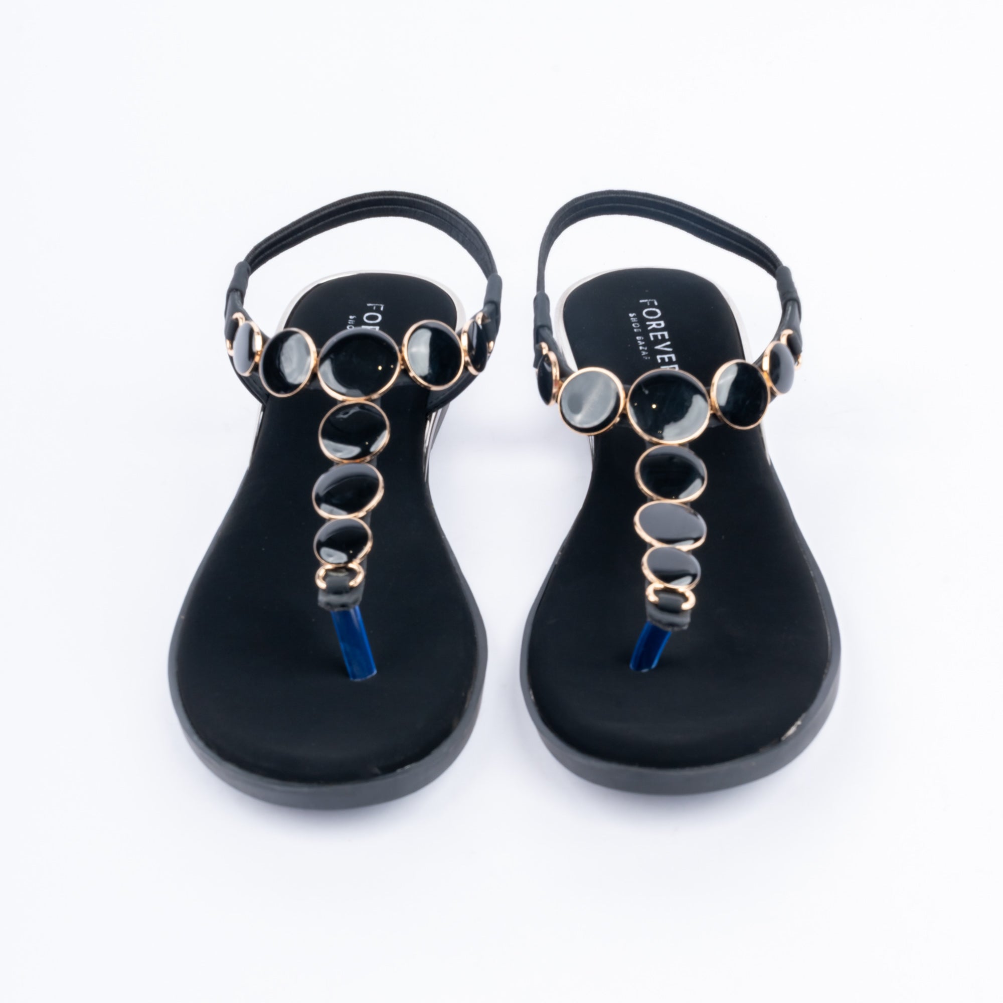 Black flat sandals styled for casual wear