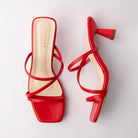Red mules for women, both shoes laid flat