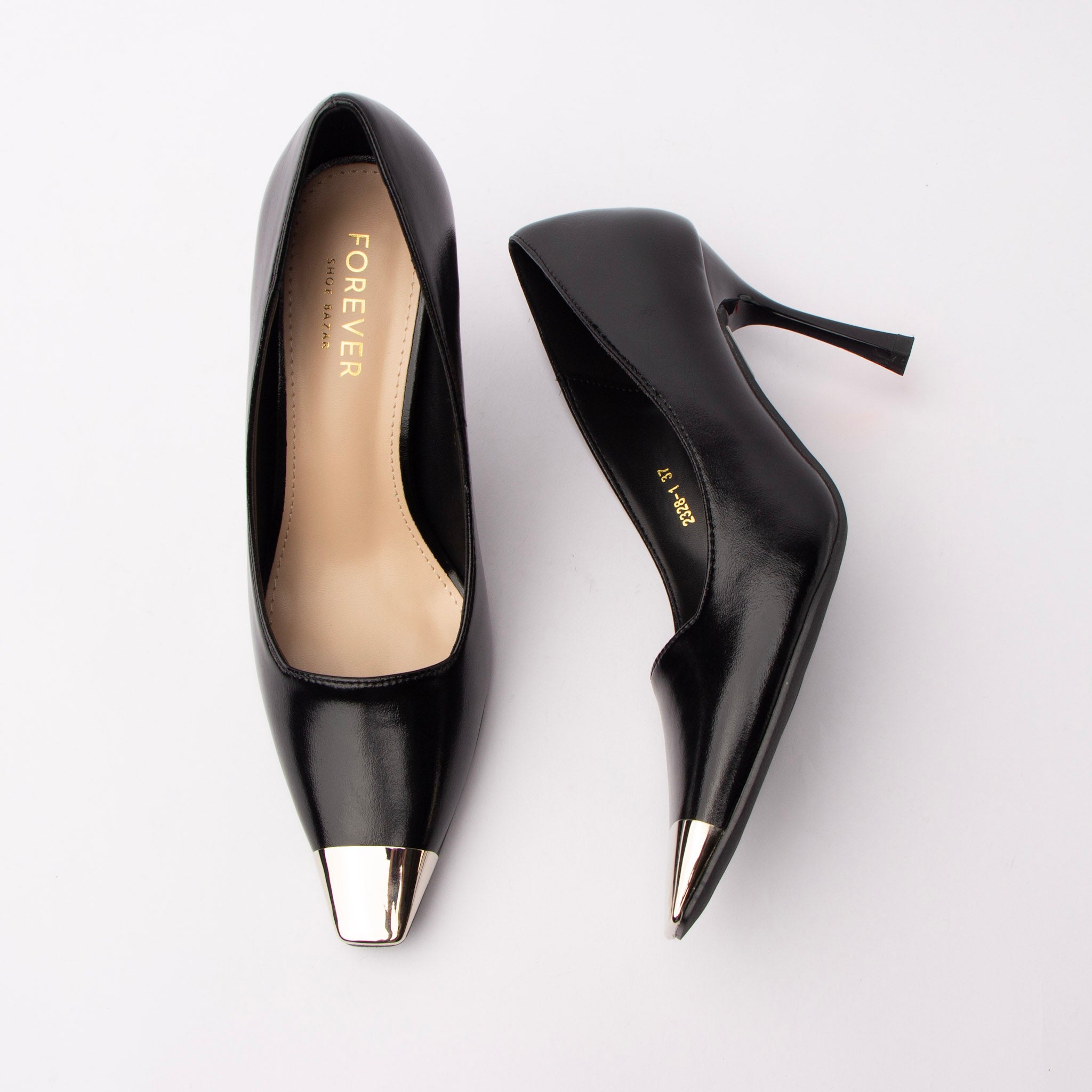 Black metal toe cap stilettos for women, a mirror-polished silver metal cap wraps the squared toe of a high-shine black upper, above a slim tapered stiletto with a squared tip, a deep v-notch at the vamp opening and a cream lined footbed