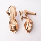 Champagne peep toe platform heels for women, warm rose-gold foiled snake-embossed leatherette formed into a single wide vamp band and a fine buckled ankle strap, set over a covered toe platform and flared block heel, with a champagne-gold footbed and a pale nude sole edge and heel tip