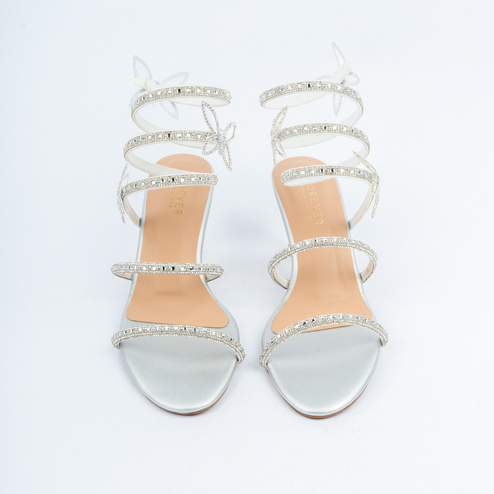 Silver block heel sandals for women, two crystal-paved bands across the forefoot feeding a rhinestone coil that spirals three times up the ankle, punctuated by tiny crystal butterflies