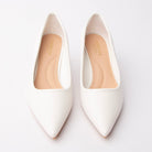 White pointed kitten heels styled for everyday wear