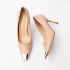 Nude metal toe cap stilettos for women, a mirror-polished silver metal cap finishes the squared toe of a smooth matte nude upper, above a slim tapered stiletto with a squared beige heel tip, a softly notched v vamp opening and a tonal cream footbed