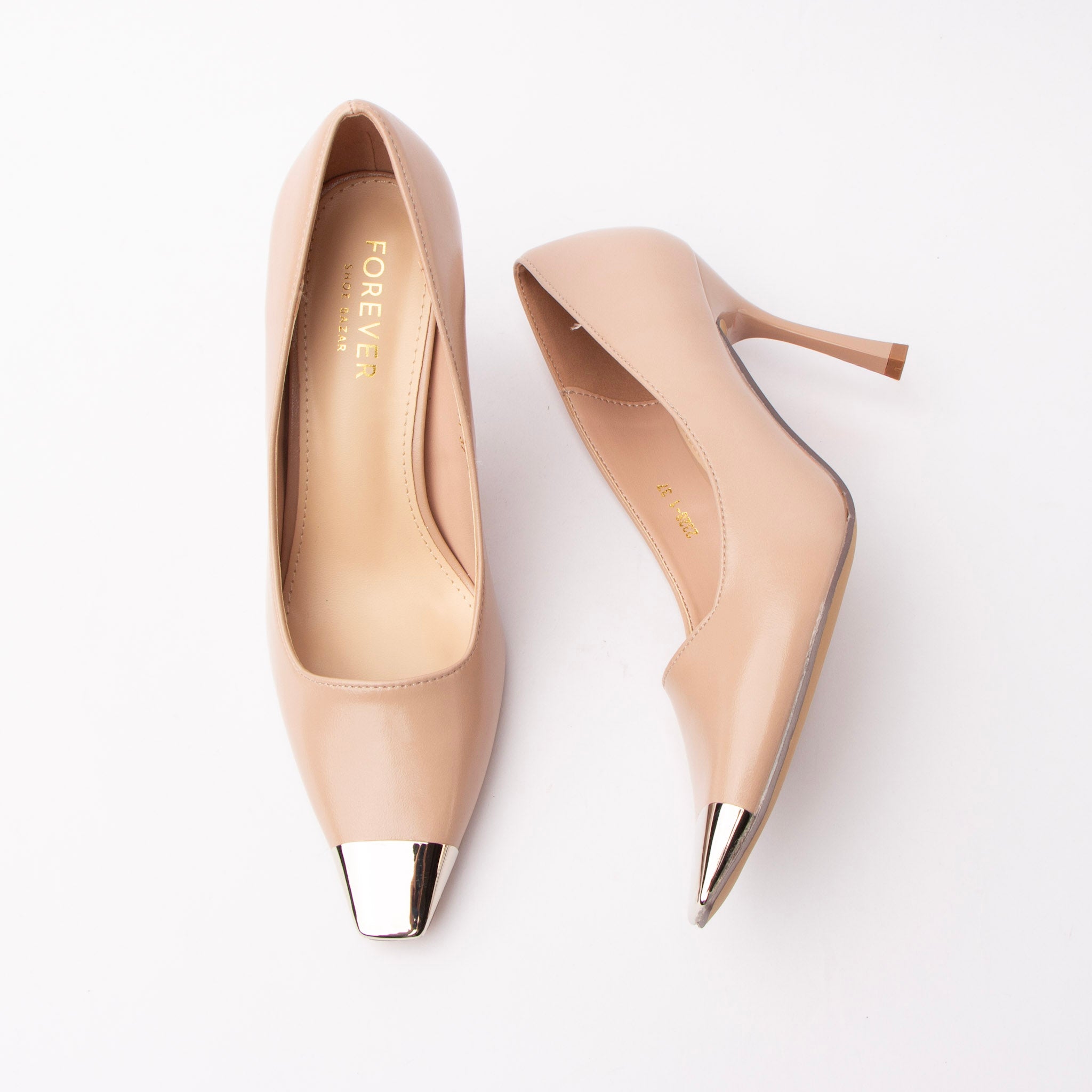 Nude metal toe cap stilettos for women, a mirror-polished silver metal cap finishes the squared toe of a smooth matte nude upper, above a slim tapered stiletto with a squared beige heel tip, a softly notched v vamp opening and a tonal cream footbed