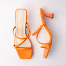 Orange mules for women, both shoes laid flat